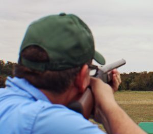 Hunter aiming shotgun with open sights